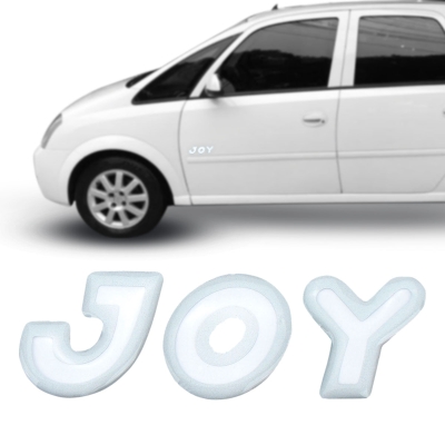 Emblema 'JOY' - Chevrolet Meriva / Corsa 2003/2006 - Transparente / Contorno Prata / Resinado